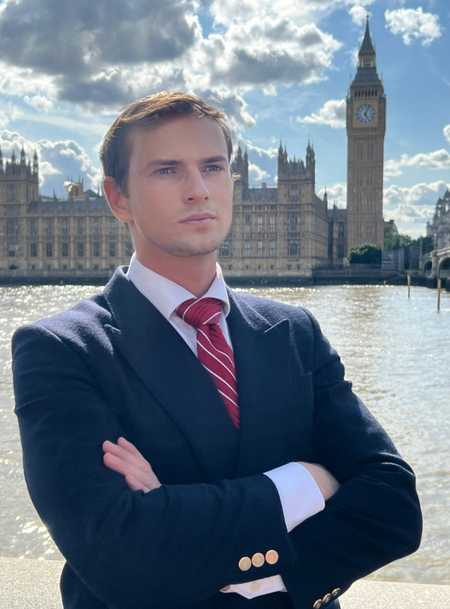 Elvijs Plugis standing near Big Ben London, Fractional CMO and business growth advisor